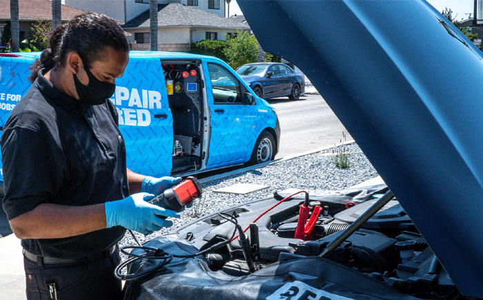 Technician servicing vehicle 